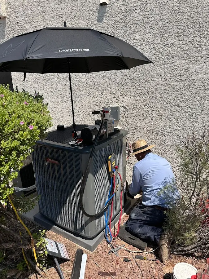HVAC technician performing outdoor AC maintenance in Five Forks